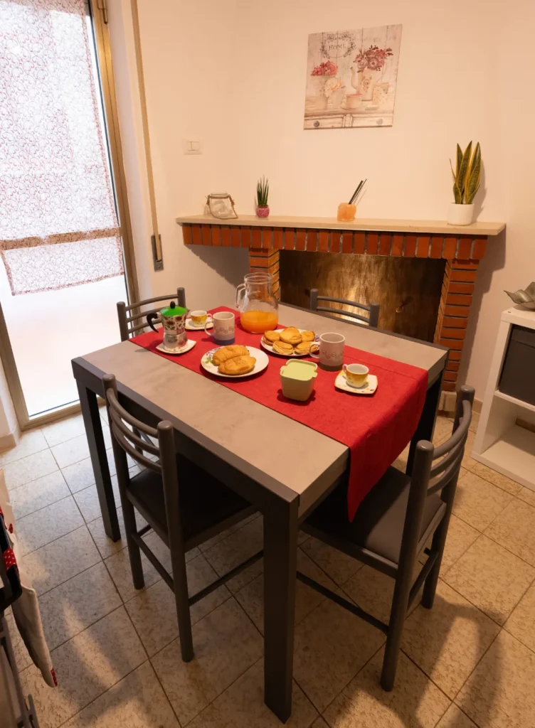 The Casa Bruna table laid for breakfast, next to the fireplace
